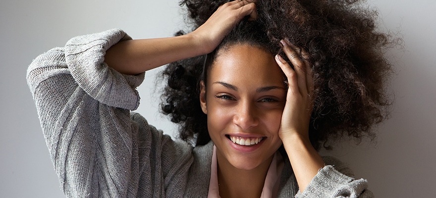 Beautiful Woman Smiling With Hands In Hair